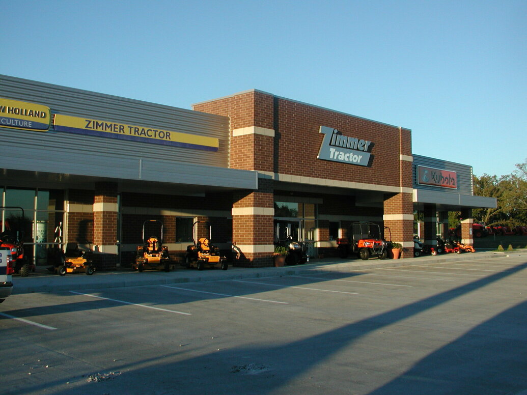front of Zimmer Tractor building with mowers